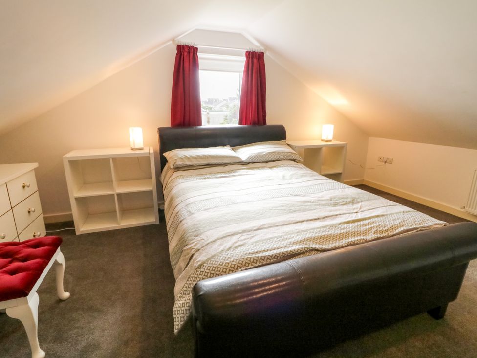A bedroom with a bed and lamp at 3 Warke Place Castlerock