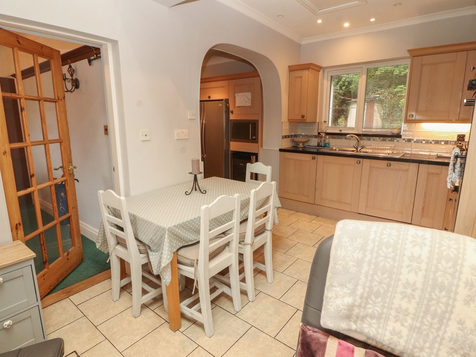 A kitchen with a dining table and chairs at High Cross in Keswick
