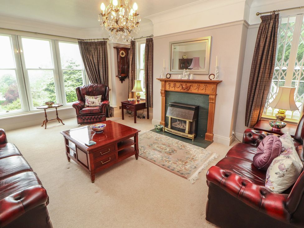 A living room with furniture including sofas and a fireplace at High Cross in Keswick