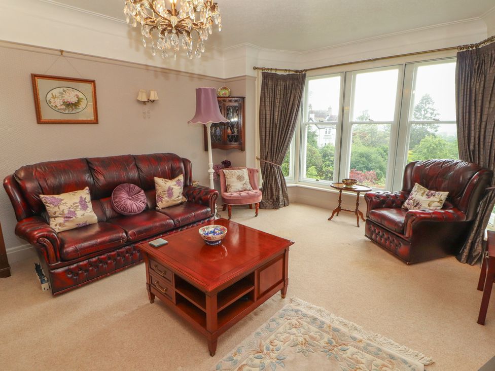 A living room with a sofa and armchair at High Cross in Keswick