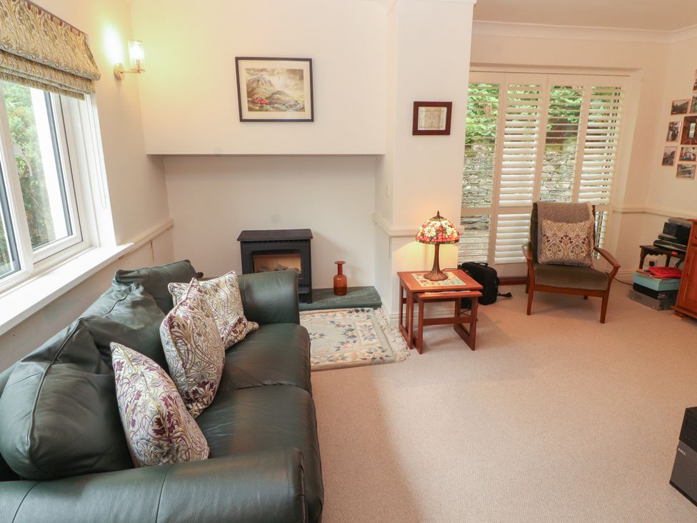 A living room with a sofa and fireplace at High Cross in Keswick