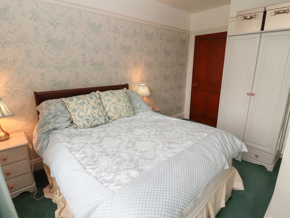 A bedroom with a bed and nightstand at High Cross in Keswick