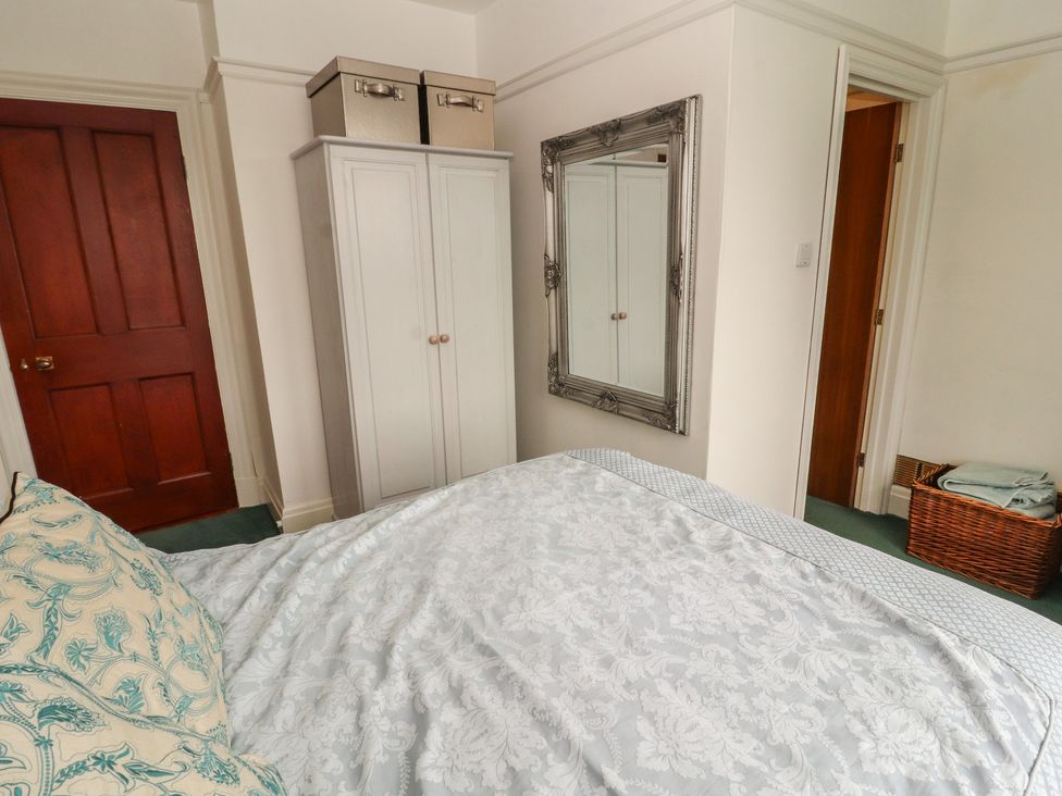 A bedroom with a wardrobe and mirror at High Cross in Keswick