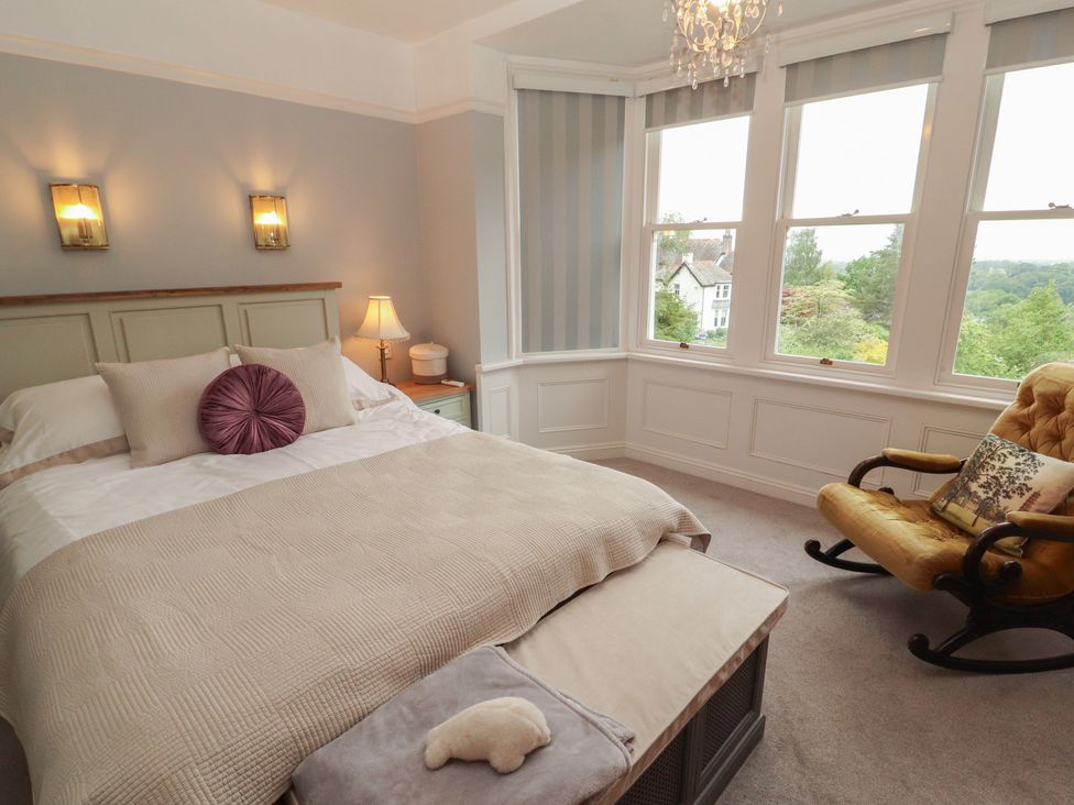 A bedroom with a bed and a rocking chair at High Cross in Keswick