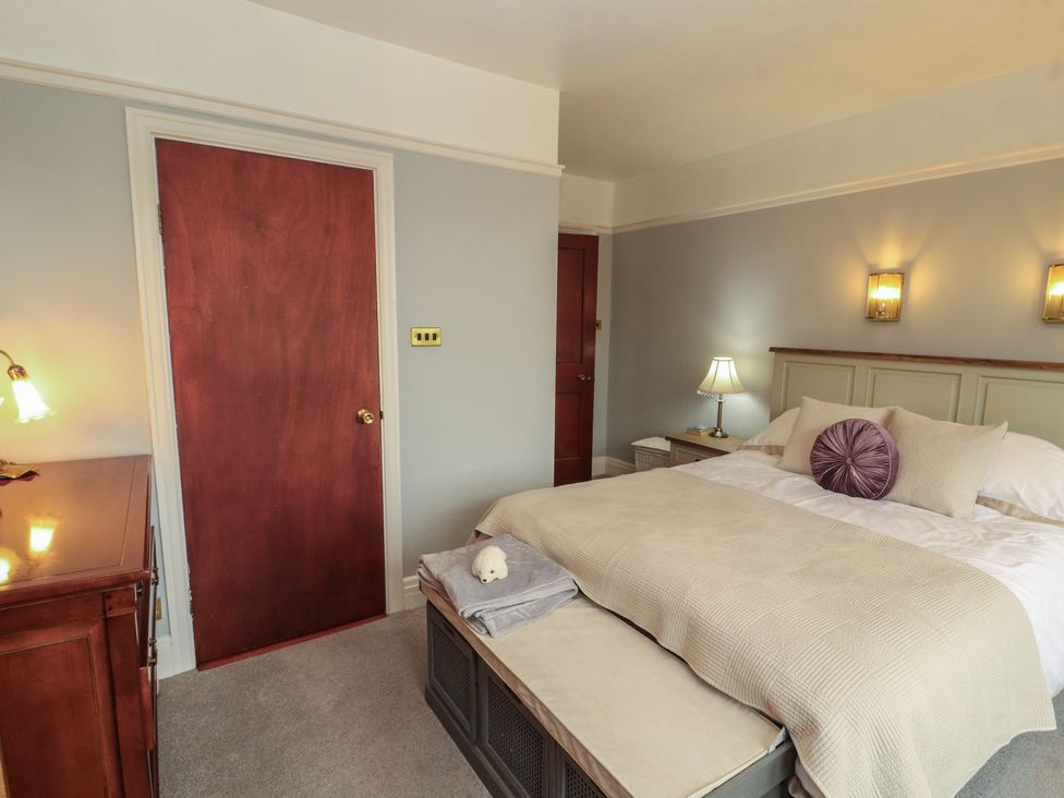 A bedroom with a bed and a dresser at High Cross in Keswick