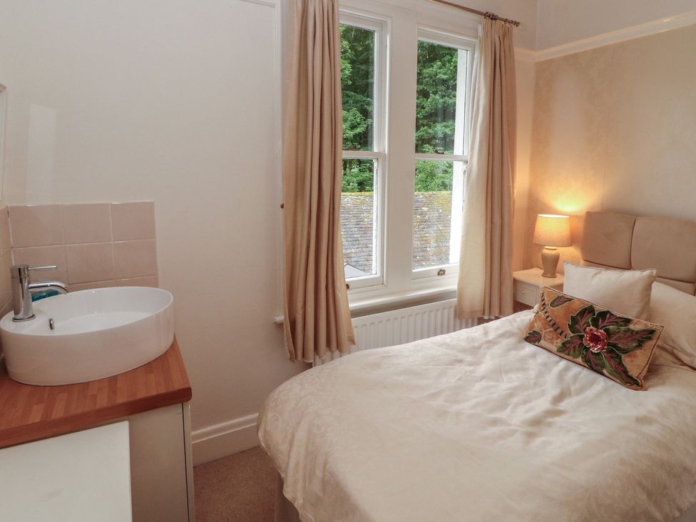 A bedroom with a bed and sink at High Cross in Keswick