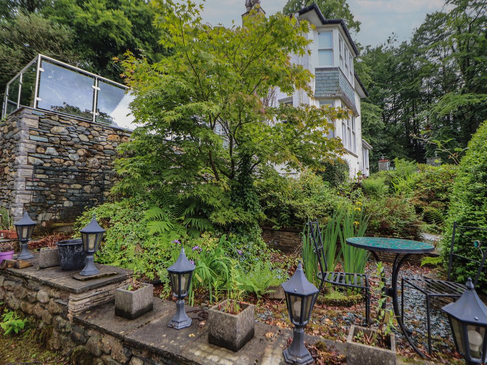 A garden with plants and seating area at High Cross in Keswick