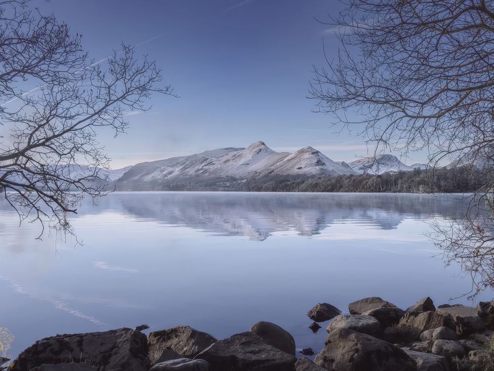 A landscape view of mountains reflecting on water at High Cross in Keswick