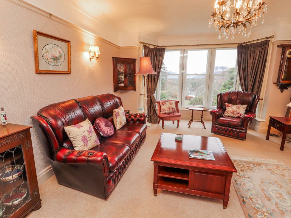 A living room with various seating and a coffee table at High Cross in Keswick