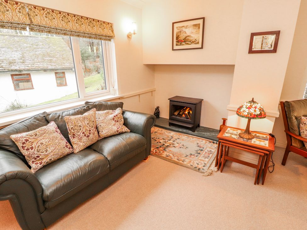 A living room with a sofa and fireplace at High Cross in Keswick