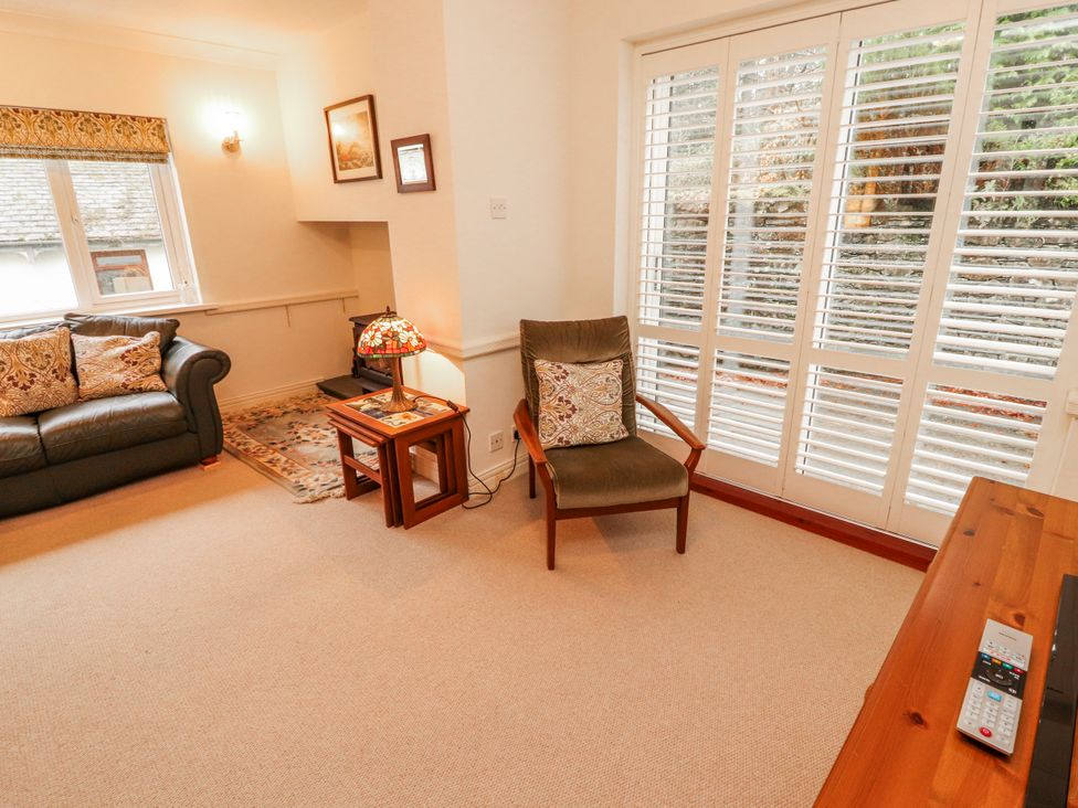 A living room with a sofa and armchair at High Cross in Keswick