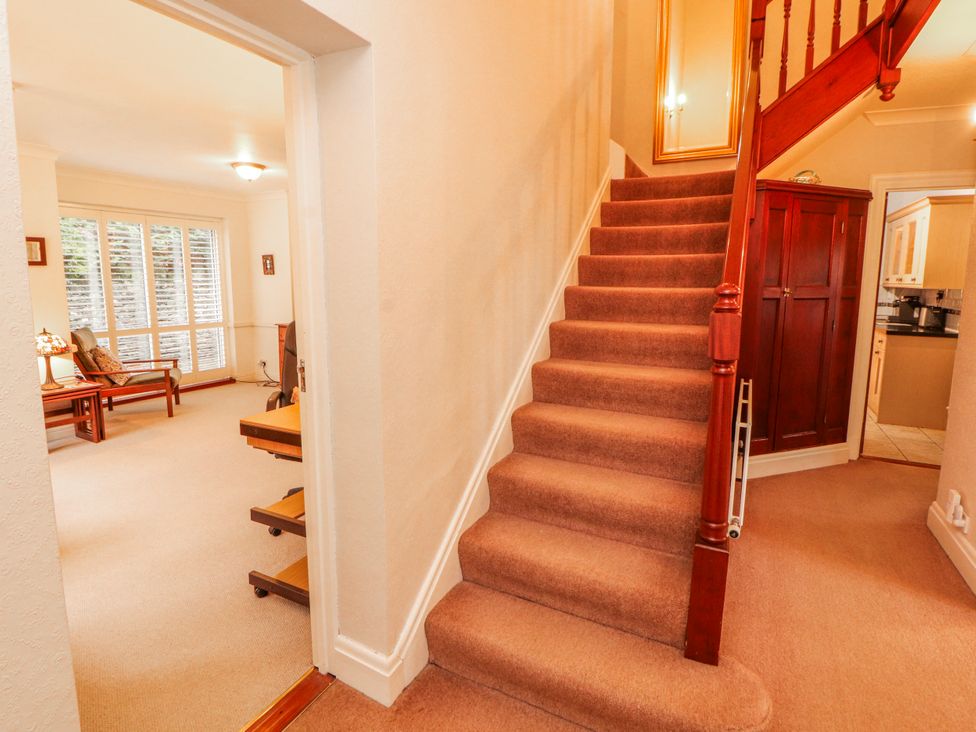 A hallway with a staircase and doorway at High Cross in Keswick