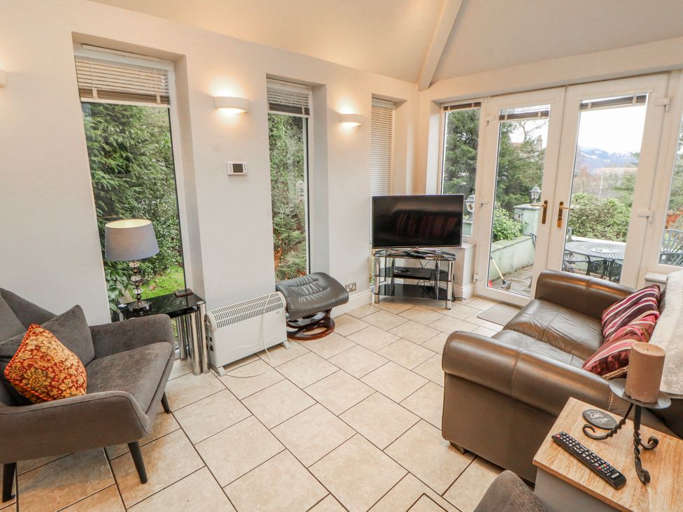 A living room with a sofa and television at High Cross in Keswick