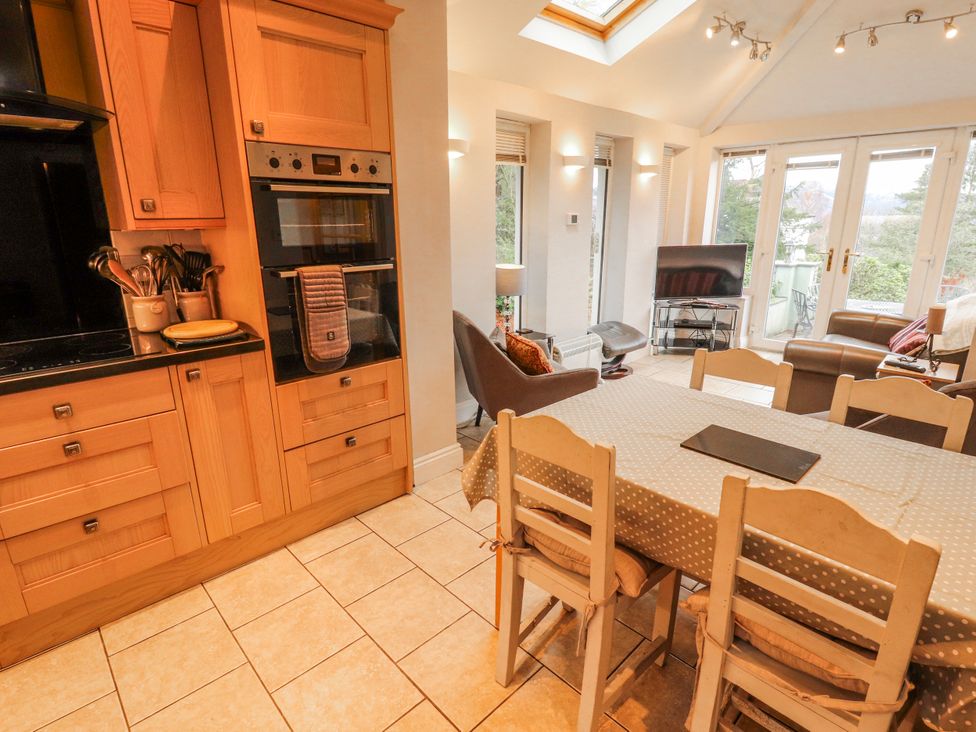 A kitchen with a dining area and sofa at High Cross in Keswick