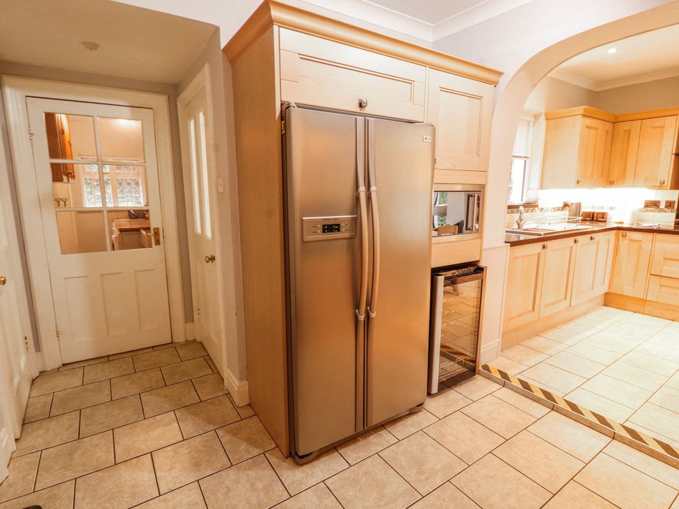 A kitchen with a refrigerator and cabinets at High Cross in Keswick