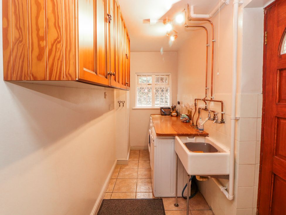 A laundry room with a sink and washing machine at High Cross in Keswick