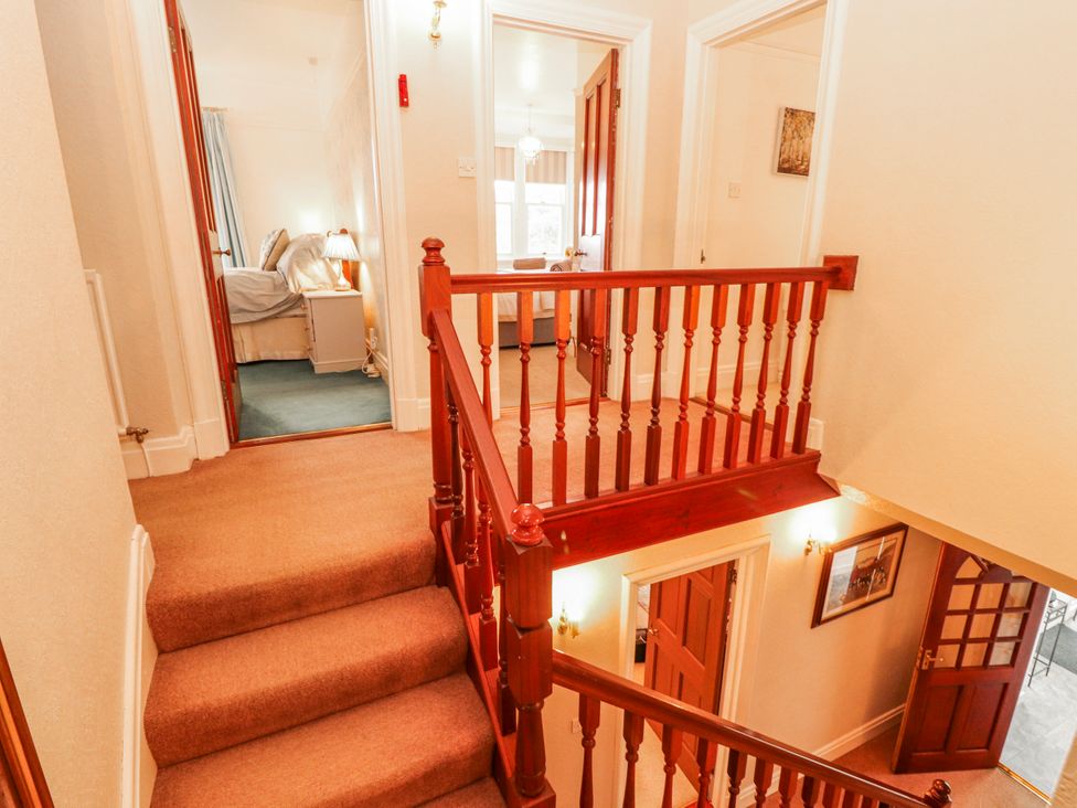 A hallway with a staircase and doors at High Cross in Keswick