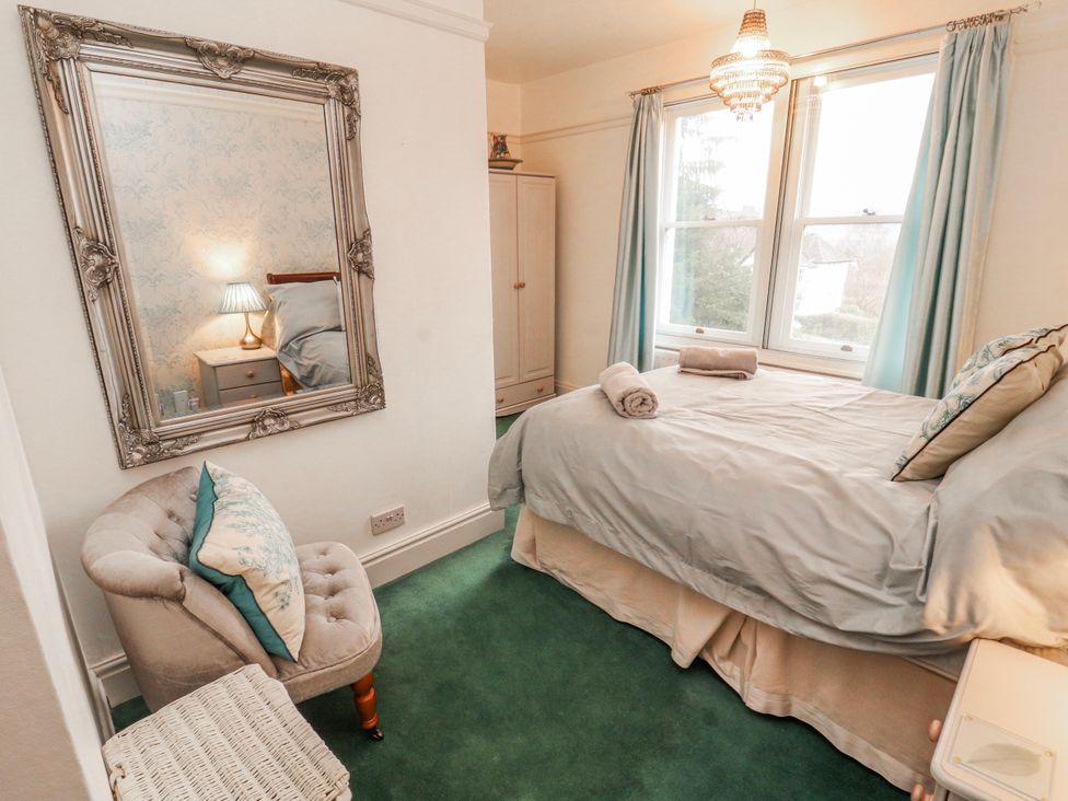 A bedroom with a bed and a nightstand at High Cross in Keswick