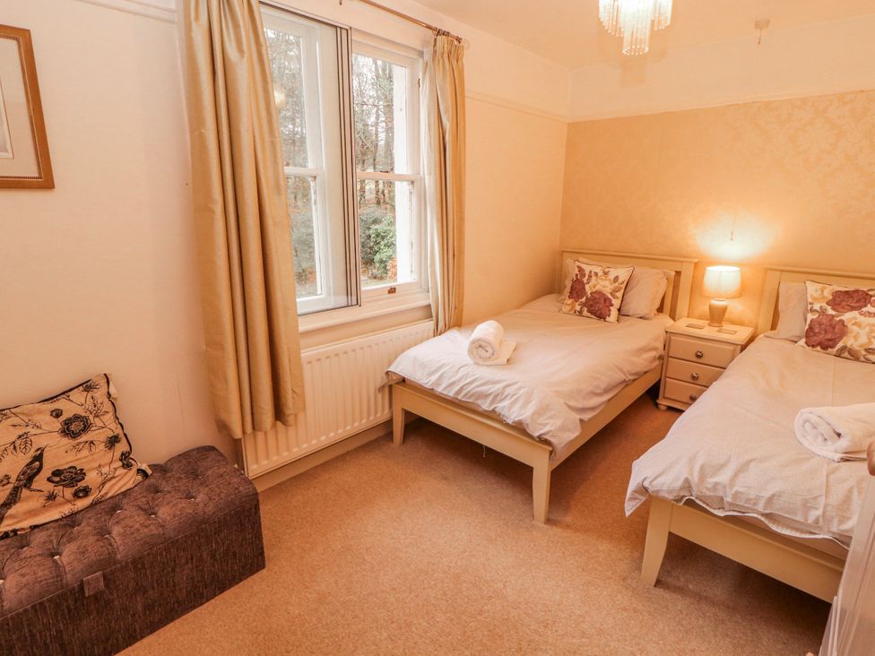 A bedroom with two beds and a sofa at High Cross in Keswick