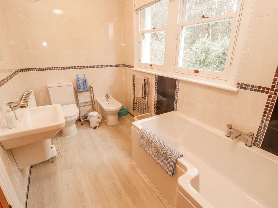 A bathroom with a bathtub, sink, and toilet at High Cross in Keswick