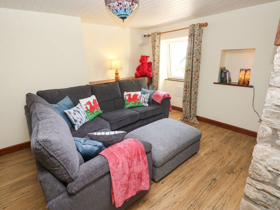 A living room with a sofa and window at Dolcoed near Llangadog