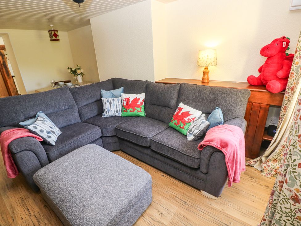 A living room with a sofa and cushions at Dolcoed near Llangadog