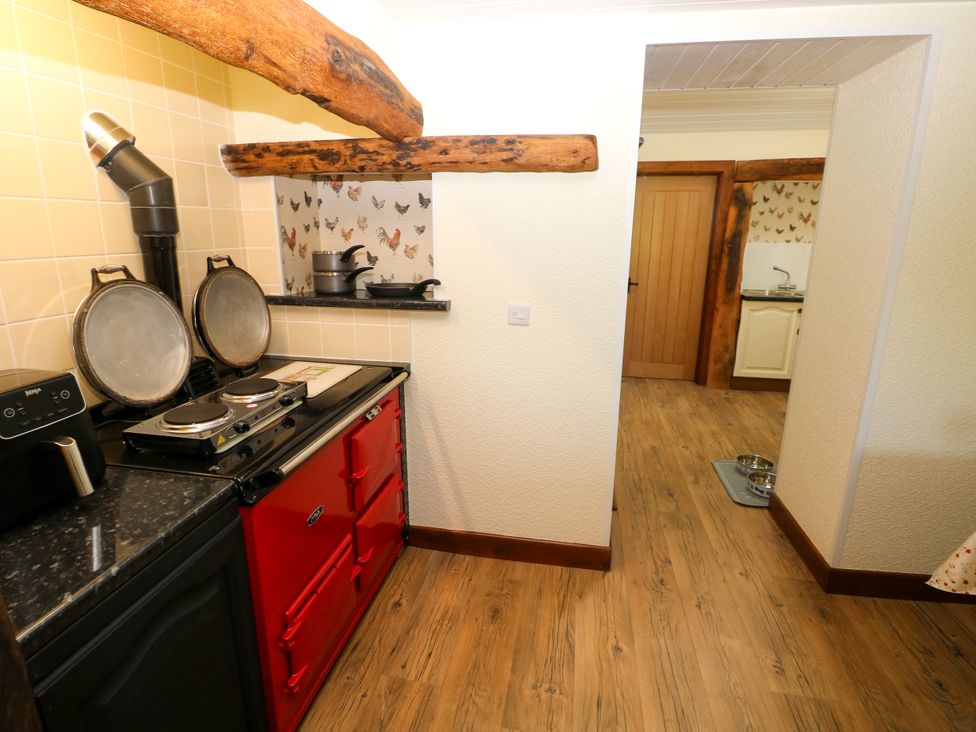 A kitchen with a stove and sink at Dolcoed Manordeilo near Llangadog