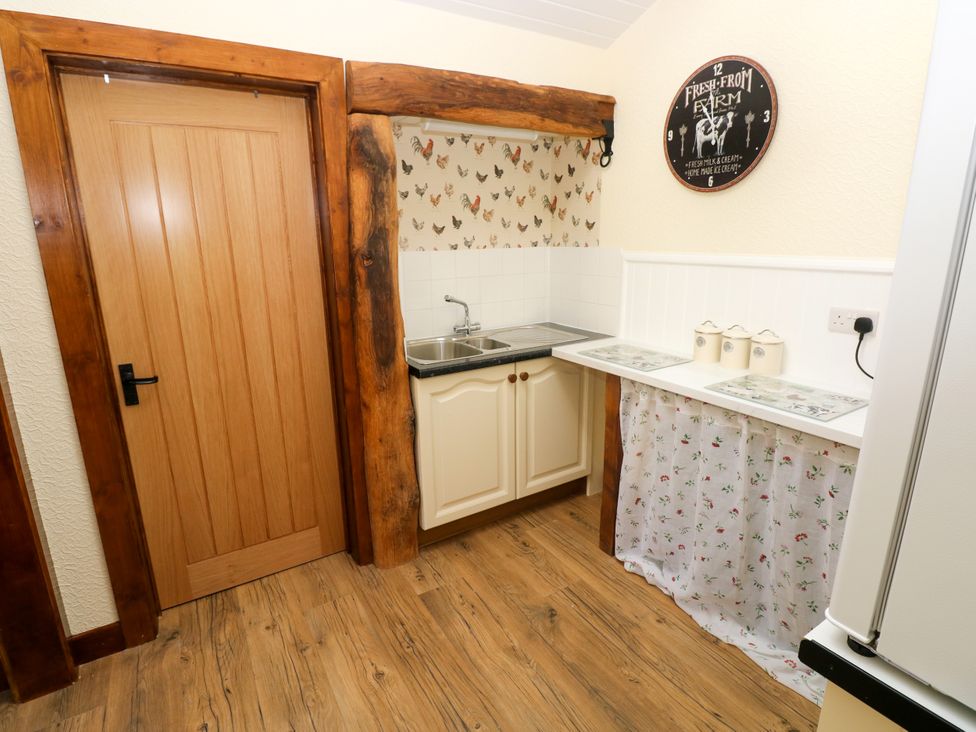 A kitchen with a sink and cabinets at Dolcoed in Manordeilo near Llangadog