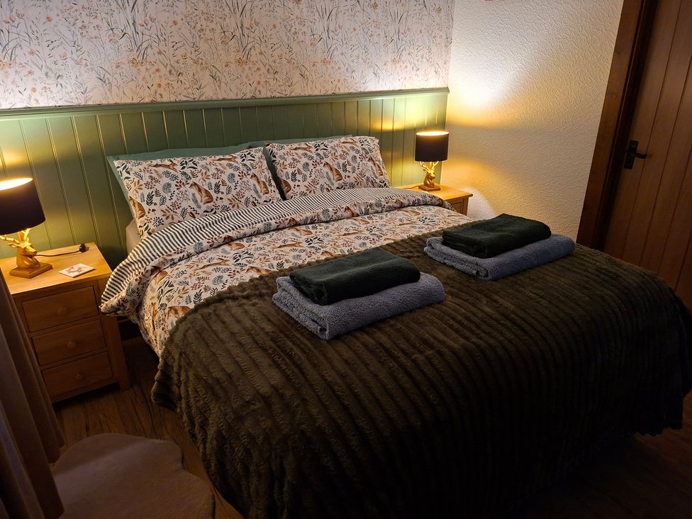 A bedroom with a bed and bedside table at Dolcoed in Llandeilo