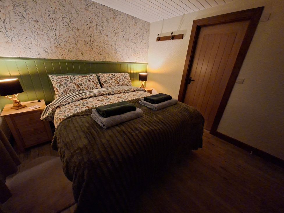 A bedroom with a bed and nightstand at Dolcoed in Llandeilo