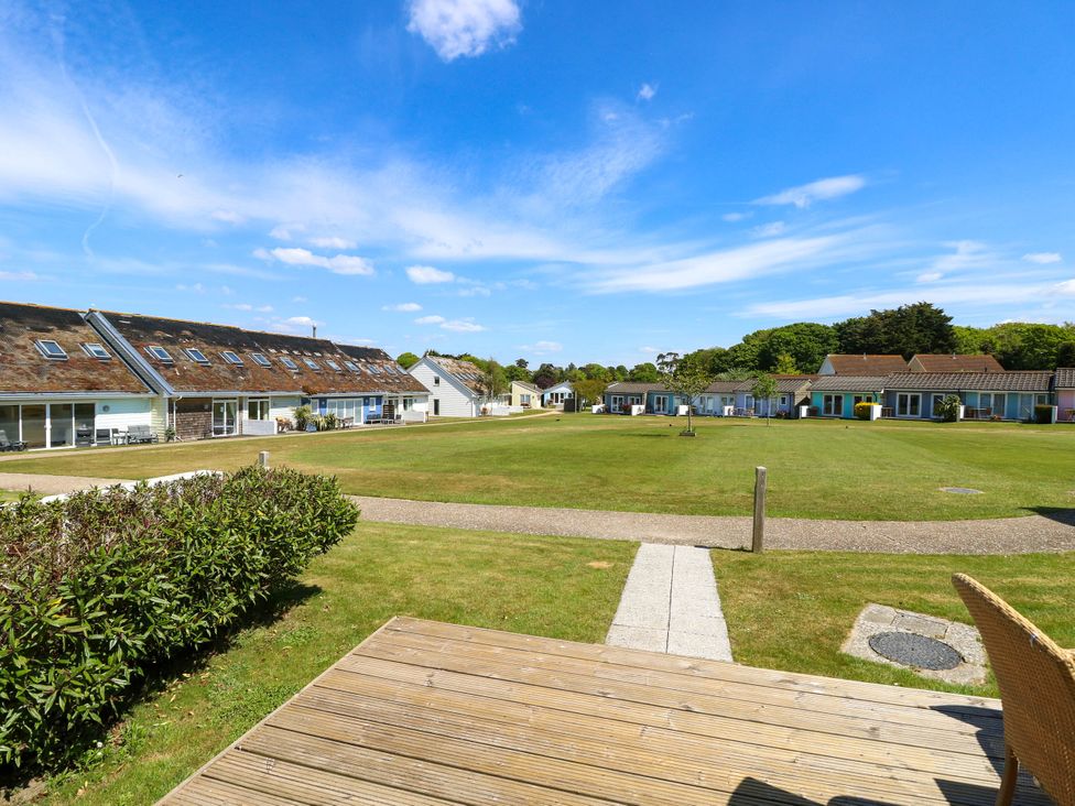 A grassy open area with pathways and small houses surrounding it at Cape 14 in Yarmouth