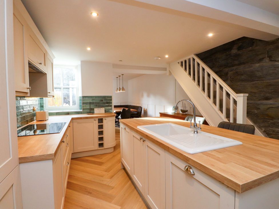 A kitchen with cabinets and a sink at 5 Lombard Street in Porthmadog
