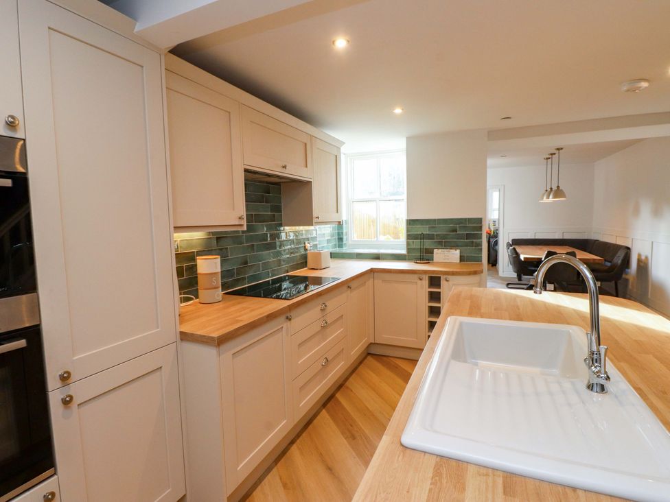 A kitchen with cabinets, a sink, and a counter at 5 Lombard Street, Porthmadog