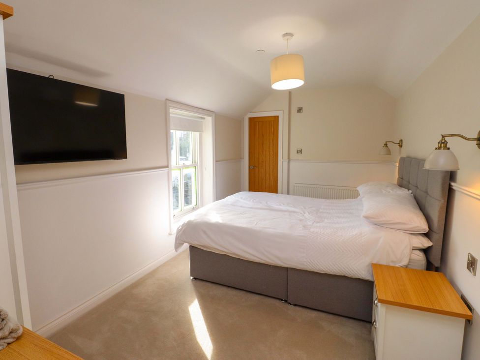 A bedroom with a bed and television at 5 Lombard Street, Porthmadog