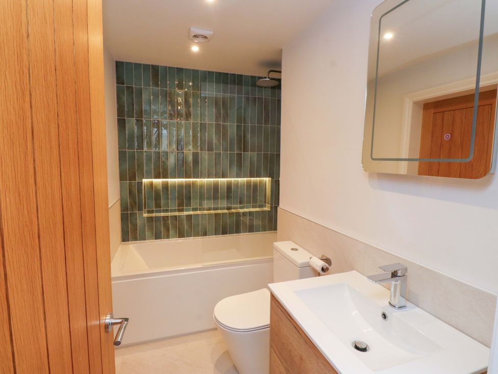 A bathroom with a bathtub, sink, and toilet at 5 Lombard Street, Porthmadog