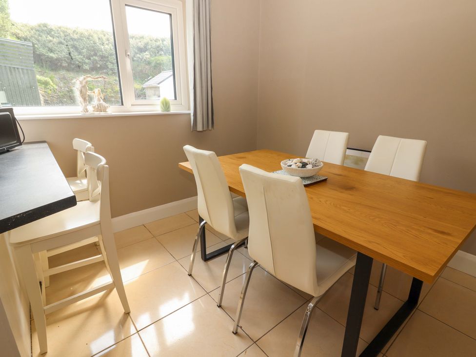 A dining room with a table and chairs at O'Conells in Portmagee