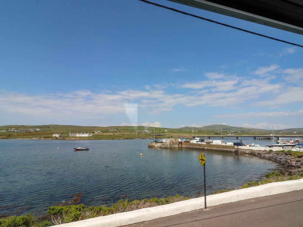A coastal view with water and boats at O'Conells Portmagee
