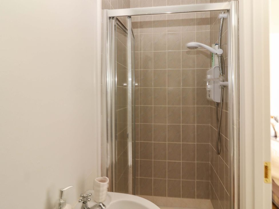 A shower with tiles and faucet in the bathroom at O'Conells in Portmagee
