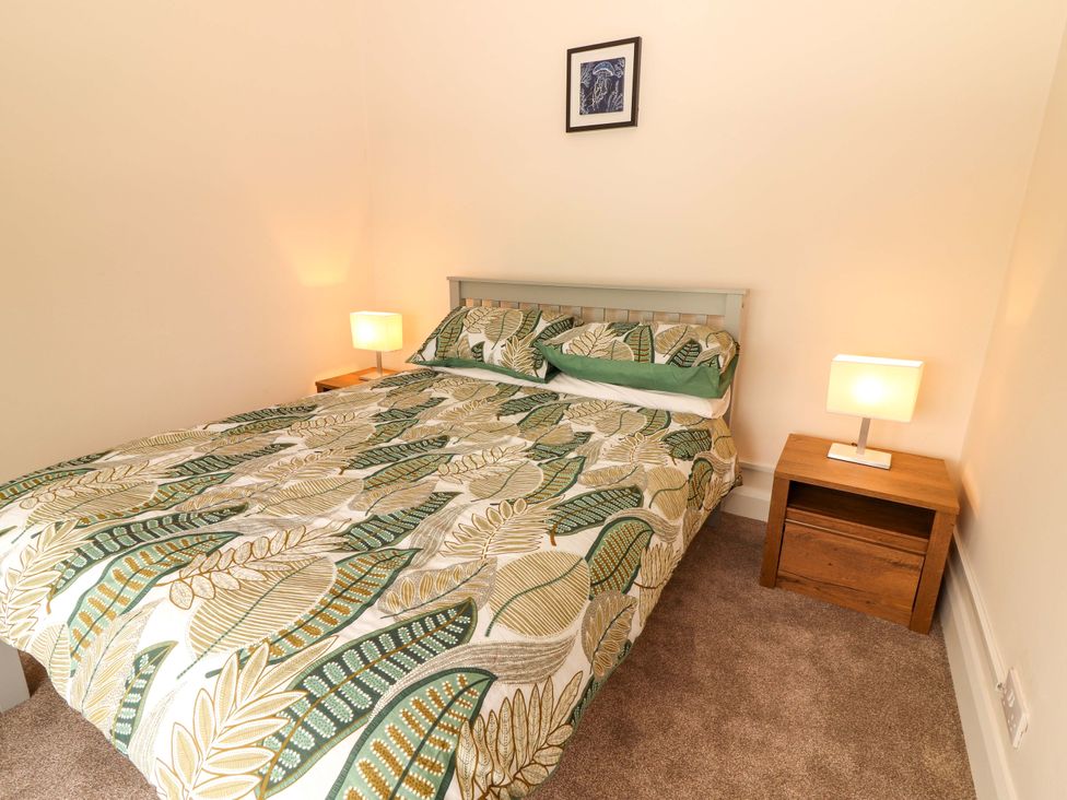 A bedroom with a bed and bedside table at O'Connell's Lodge, Portmagee, County Kerry