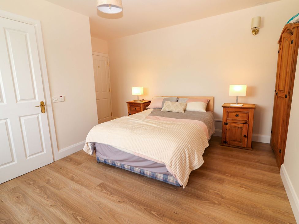 A bedroom with a bed and bedside tables at O'Connell's Lodge, Portmagee, County Kerry