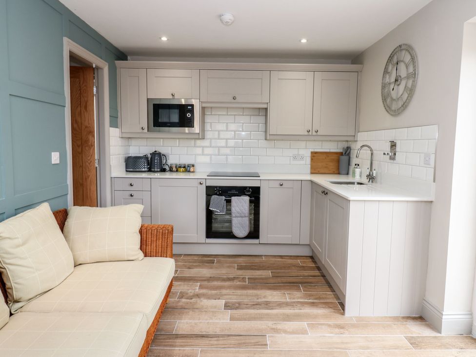 A kitchen with cabinets and appliances at Cottage 10, Brandon, County Durham