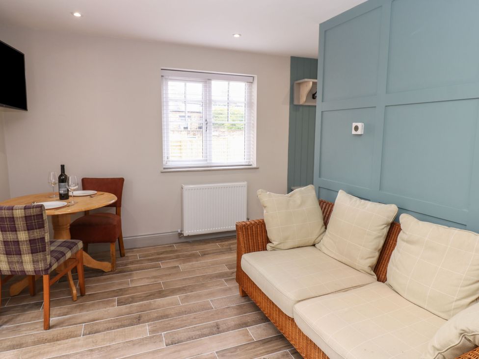 A living room with a dining area and sofa at Cottage 10 in Brandon, County Durham
