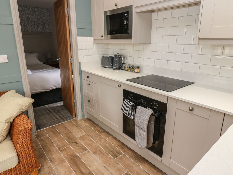 A kitchen with appliances and cabinets at Cottage 10 in Brandon, County Durham
