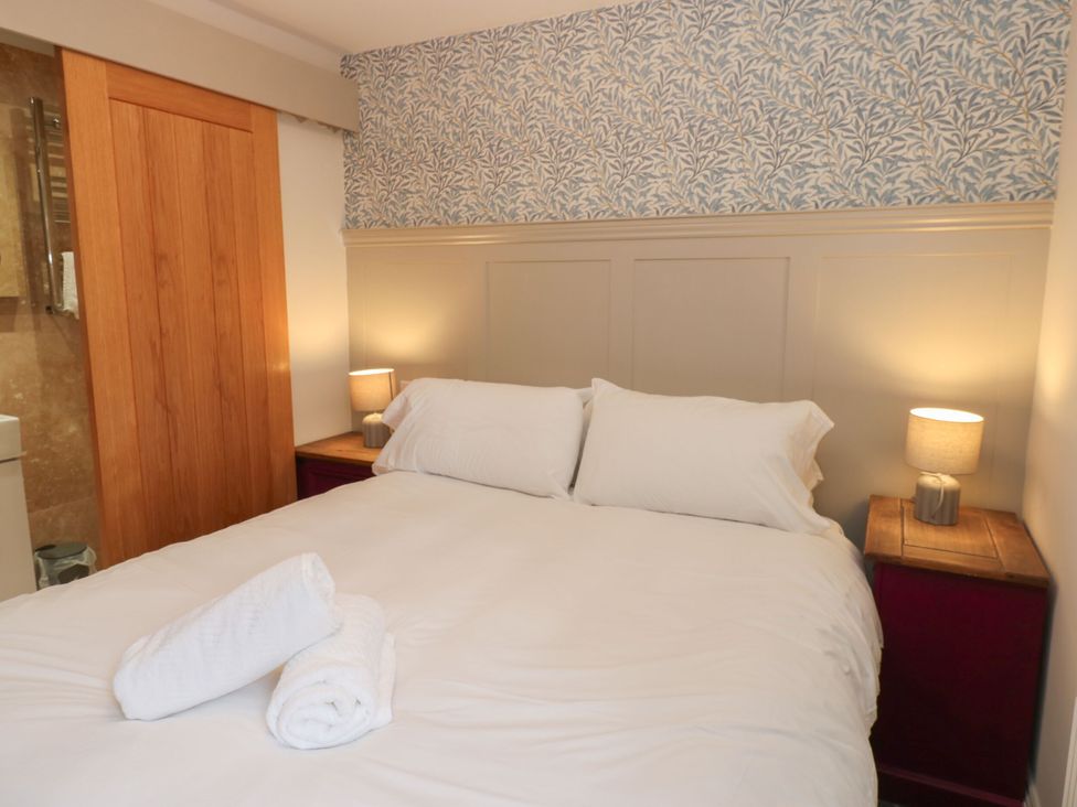 A bedroom with a bed and bedside tables at Cottage 10 in Brandon, County Durham