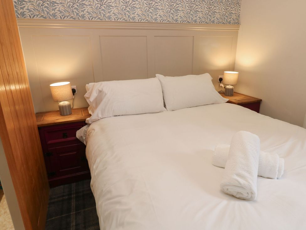 A bedroom with a bed and lamps at Cottage 10, Brandon, County Durham