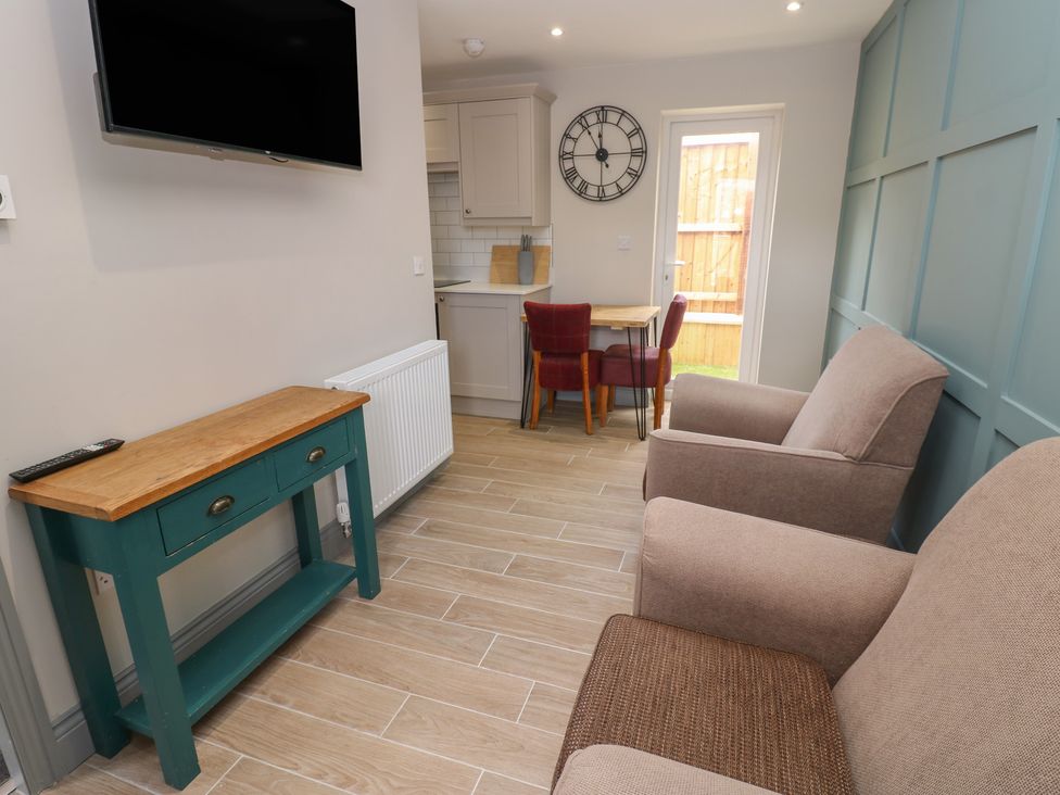 A snug with a television and sofa at Cottage 9 in Brandon, County Durham