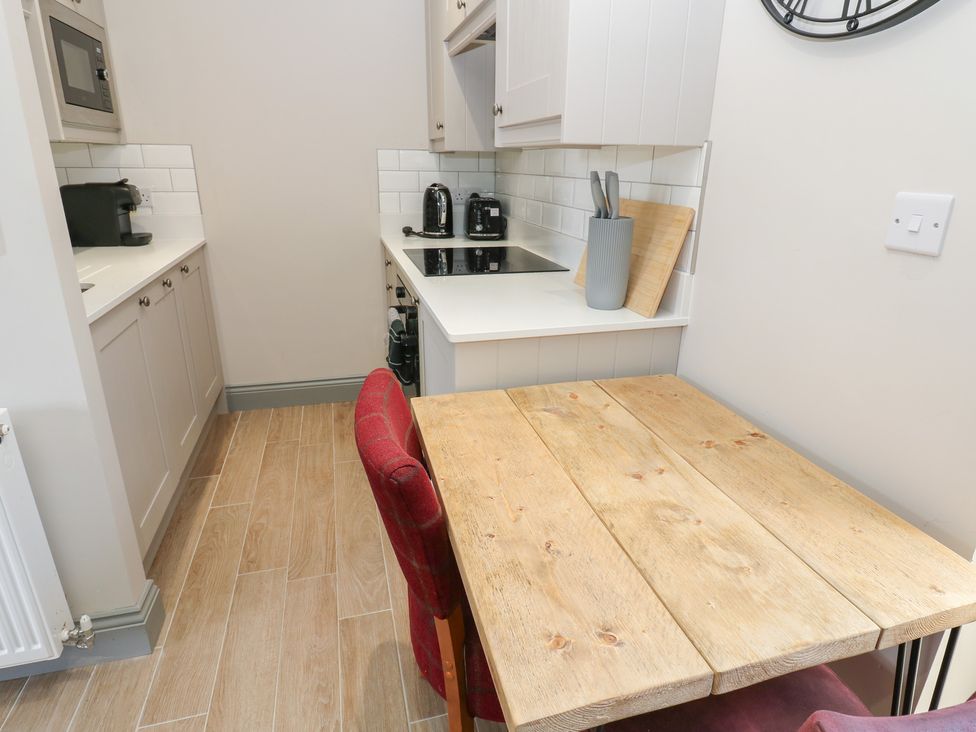 A kitchen with a table and chairs at Cottage 9 in Brandon, County Durham