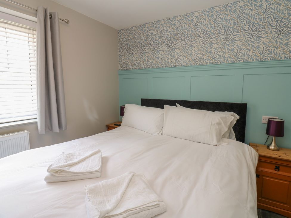 A bedroom with a bed and nightstand at Cottage 9 in Brandon, County Durham