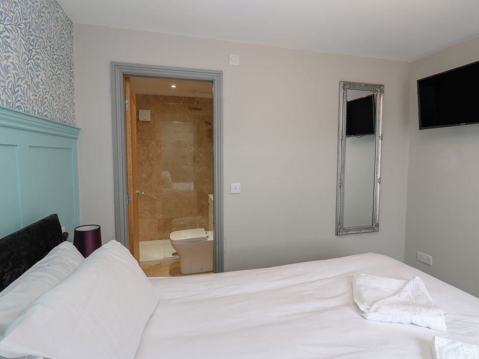 A bedroom with a bathroom doorway at Cottage 9 in Brandon, County Durham