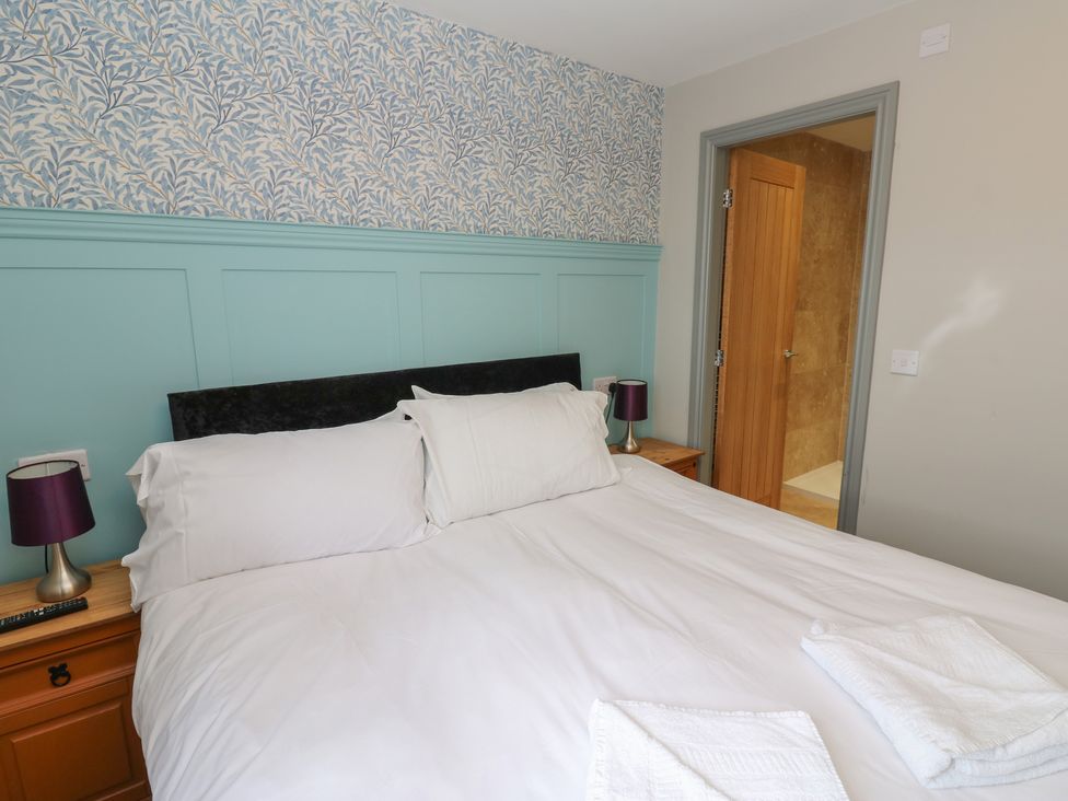 A bedroom with a bed and side tables at Cottage 9 in Brandon, County Durham